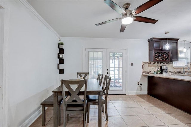 dining room featuring ornamental molding, light tile patterned floors, ceiling fan, and french doors