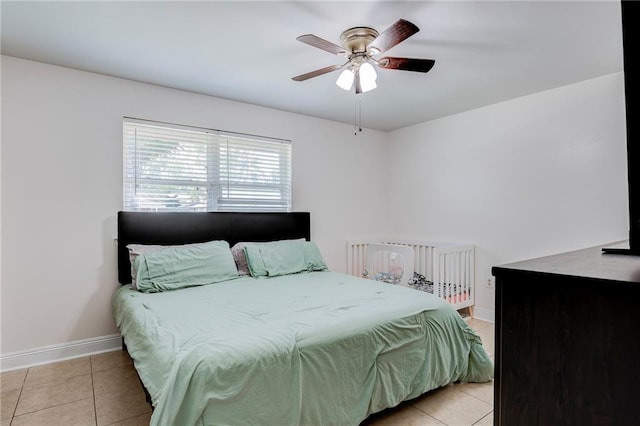 bedroom featuring light tile patterned floors and ceiling fan