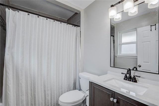 bathroom with vanity, walk in shower, and toilet