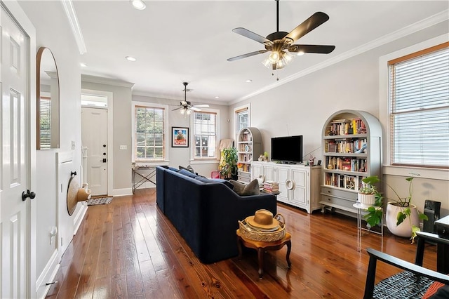 living area with hardwood / wood-style flooring, recessed lighting, baseboards, built in features, and crown molding