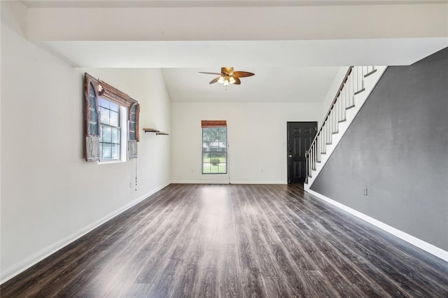 unfurnished living room featuring stairs, dark wood-style flooring, vaulted ceiling, and baseboards