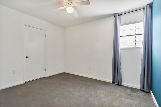 empty room featuring carpet floors, baseboards, and a ceiling fan