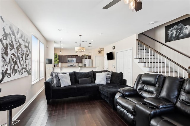 living room with dark wood-type flooring and ceiling fan