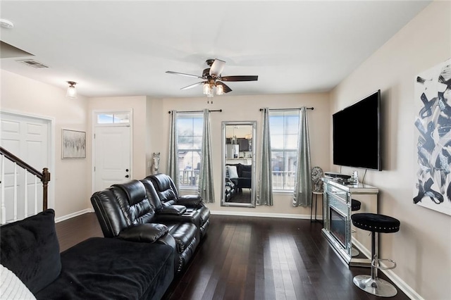 living room featuring dark hardwood / wood-style floors and ceiling fan