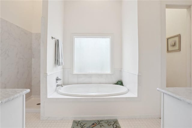 bathroom featuring tile patterned flooring, vanity, and shower with separate bathtub