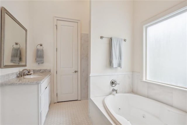 bathroom featuring vanity and tiled bath