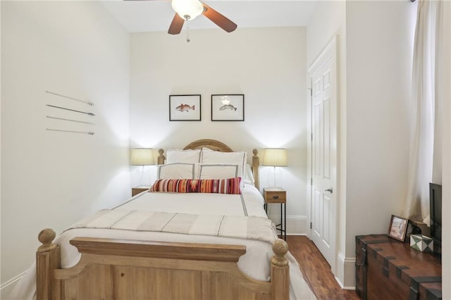 bedroom with ceiling fan and dark hardwood / wood-style flooring