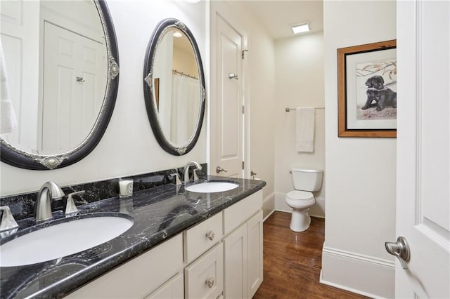 bathroom with vanity, hardwood / wood-style floors, and toilet