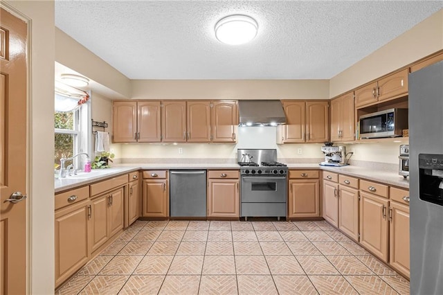 kitchen featuring a sink, wall chimney exhaust hood, stainless steel appliances, and light countertops