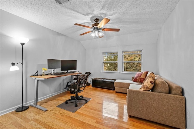 office with wood-type flooring, lofted ceiling, a textured ceiling, and ceiling fan