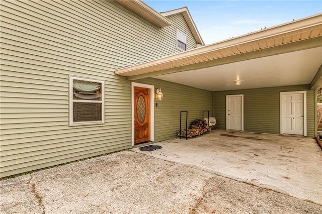 entrance to property featuring a carport