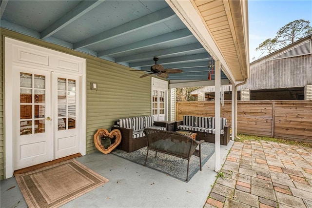 view of patio / terrace with ceiling fan, fence, an outdoor living space, and french doors