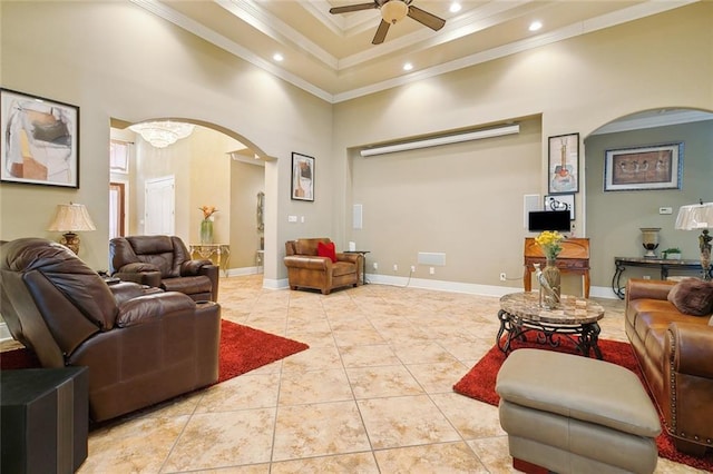 tiled living room featuring a high ceiling, crown molding, ceiling fan, and a tray ceiling