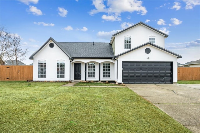 view of front of house featuring driveway, a front yard, fence, and stucco siding