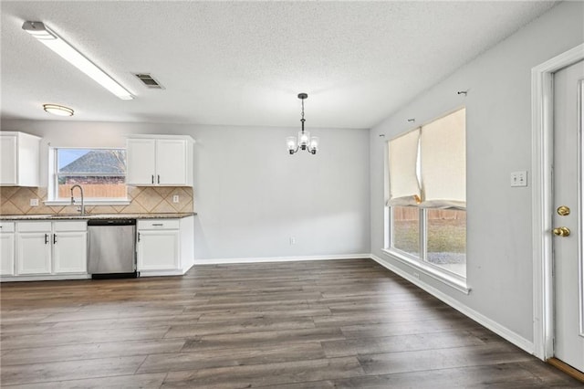 kitchen featuring dishwasher, backsplash, visible vents, and dark wood-style floors