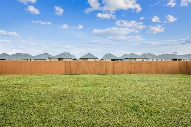 view of yard with a residential view and fence