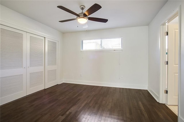 unfurnished bedroom with dark wood-type flooring, ceiling fan, and a closet