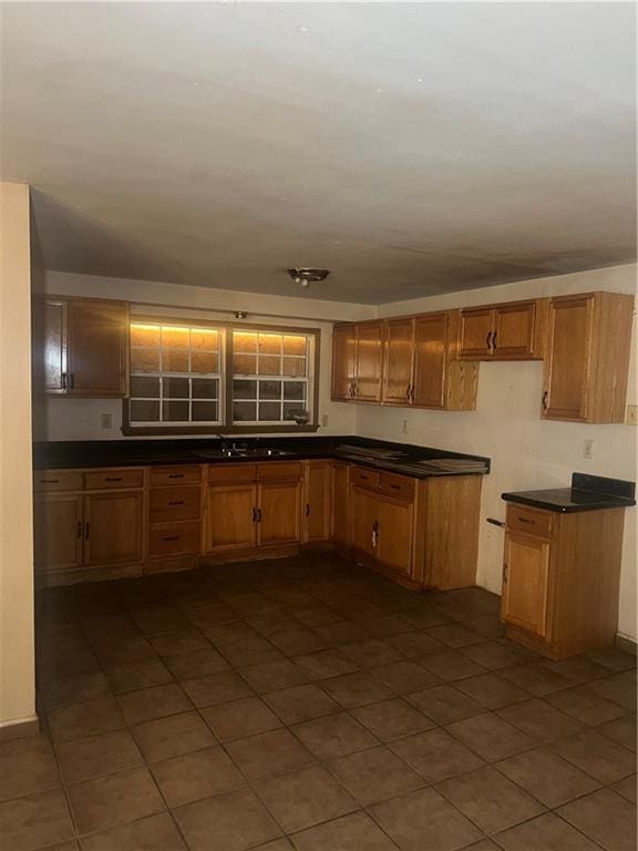 kitchen with dark tile patterned flooring