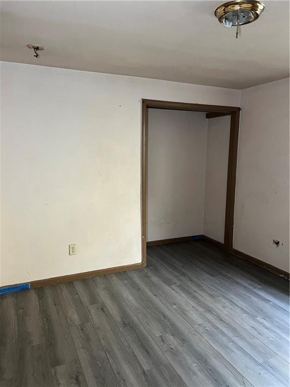 spare room featuring wood-type flooring