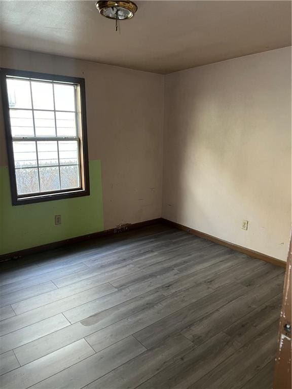 unfurnished room featuring hardwood / wood-style flooring