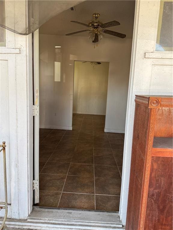 hall featuring dark tile patterned floors