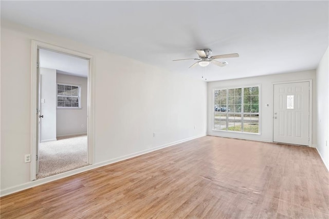 unfurnished living room with ceiling fan and light wood-type flooring