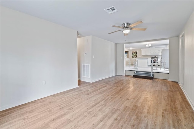 unfurnished living room with ceiling fan and light wood-type flooring