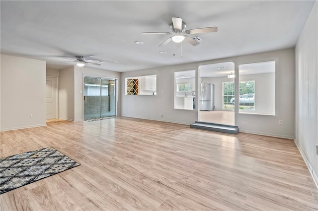 unfurnished living room featuring ceiling fan and light wood-type flooring