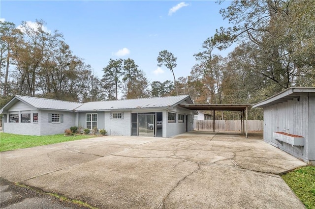 back of property featuring a carport