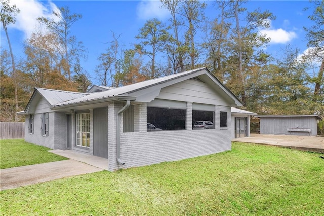 view of side of home featuring a garage and a lawn