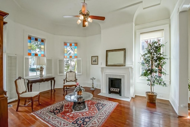 living area with ceiling fan and hardwood / wood-style floors