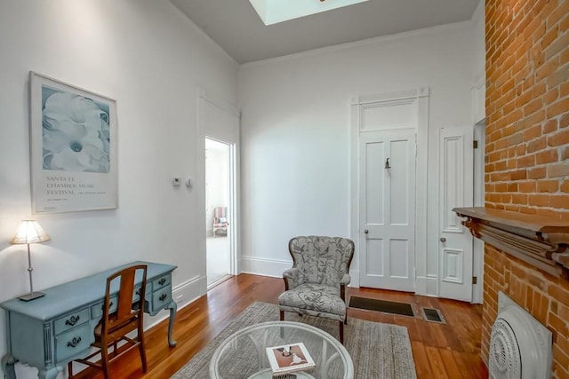 living area featuring hardwood / wood-style floors and a skylight