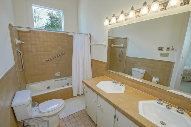 full bathroom with tile patterned floors, toilet, shower / tub combo, tile walls, and vanity