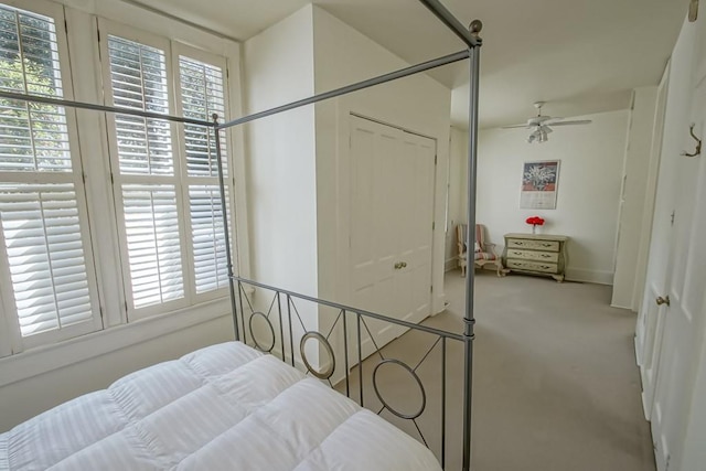 bedroom with light carpet and a closet