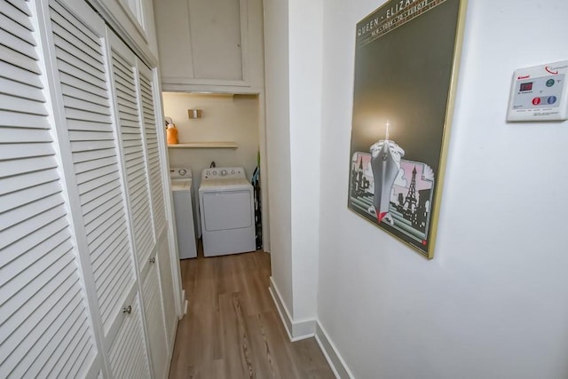 washroom featuring washer and clothes dryer and light hardwood / wood-style floors