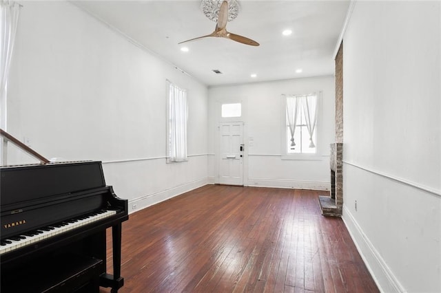 misc room with ceiling fan and dark hardwood / wood-style floors