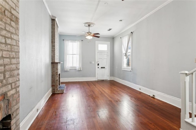 unfurnished living room with a brick fireplace, crown molding, dark hardwood / wood-style floors, and ceiling fan