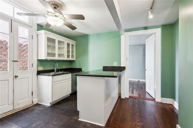 kitchen with sink, white cabinets, stainless steel dishwasher, ceiling fan, and kitchen peninsula