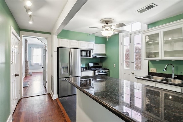 kitchen with sink, appliances with stainless steel finishes, dark hardwood / wood-style flooring, ceiling fan, and white cabinets