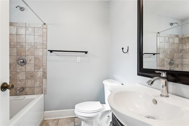 full bathroom with tile patterned flooring, tiled shower / bath combo, sink, and toilet