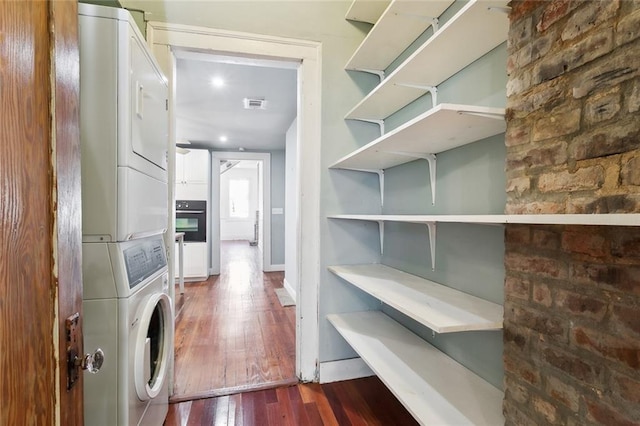 interior space featuring stacked washer and clothes dryer