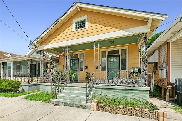 bungalow-style house featuring a sunroom and a porch