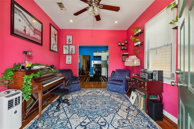 sitting room featuring ceiling fan and hardwood / wood-style floors