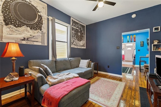 living room featuring hardwood / wood-style floors and ceiling fan