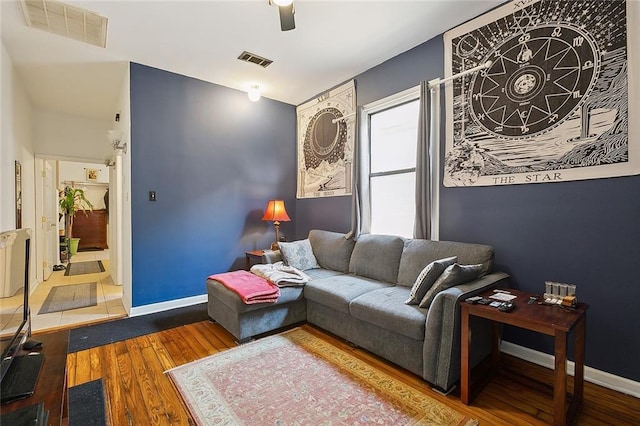 living room featuring wood-type flooring and ceiling fan