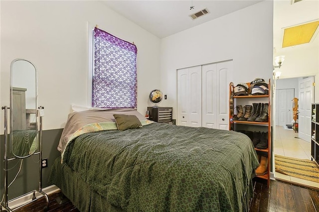 bedroom with wood-type flooring and a closet