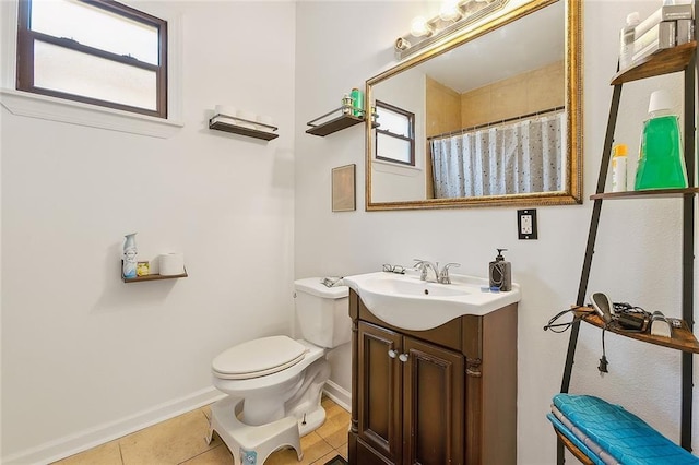 bathroom with tile patterned flooring, vanity, toilet, and walk in shower