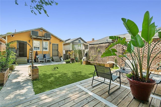 wooden terrace with a yard