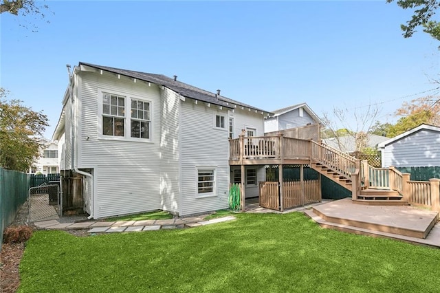 back of property featuring a yard and a deck