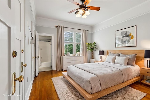 bedroom featuring hardwood / wood-style flooring, crown molding, and ceiling fan